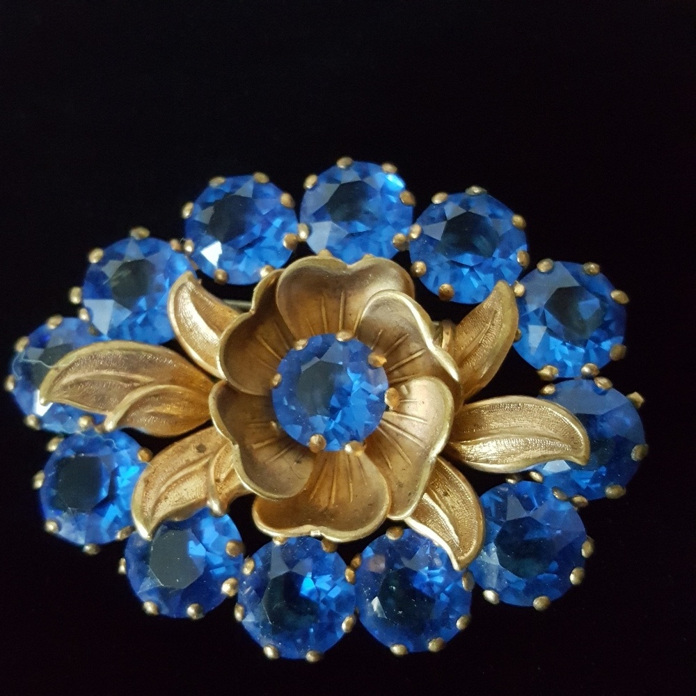 Vintage Cornflower Blue Sapphire color with Colton’s brass flower Brooch
